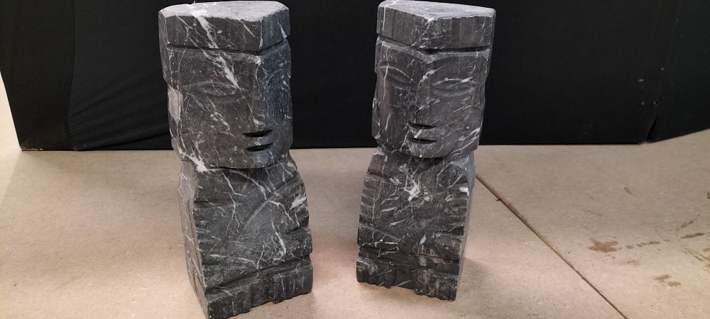 Lot 298: A Pair of Carved Grey Veined Marble Stylised Head Sculptures