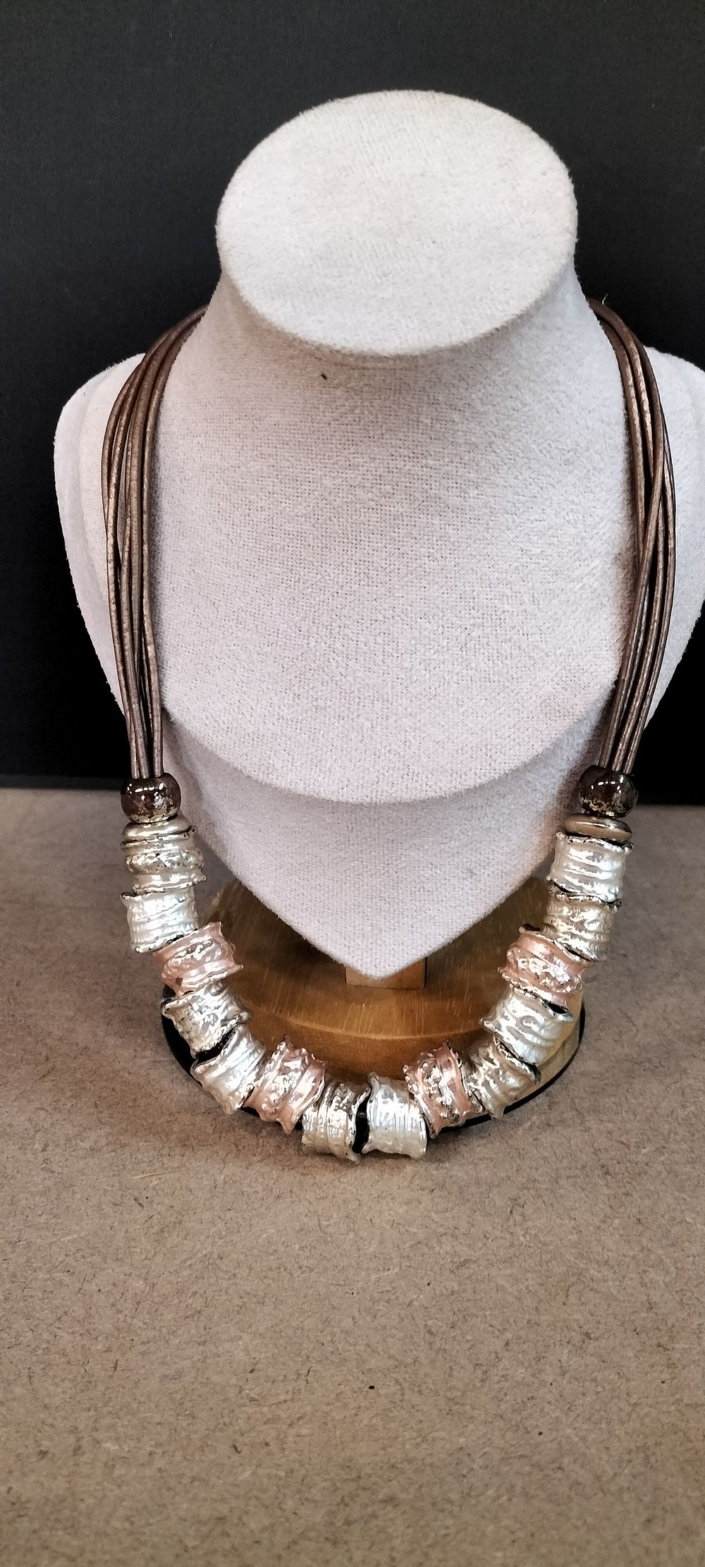 Lot 368: A 4-Strand Mixed-Metal Tone Cord Necklace with Hammered Barrel Beads