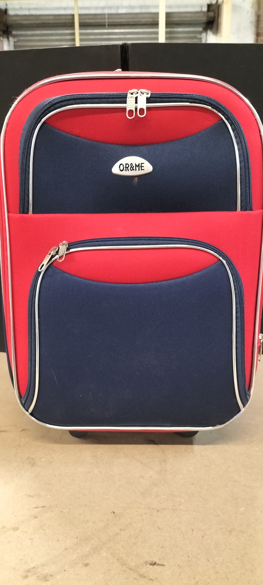 Lot 213: An OR&ME Synthetic Textile Two-Tone Upright Rolling Suitcase