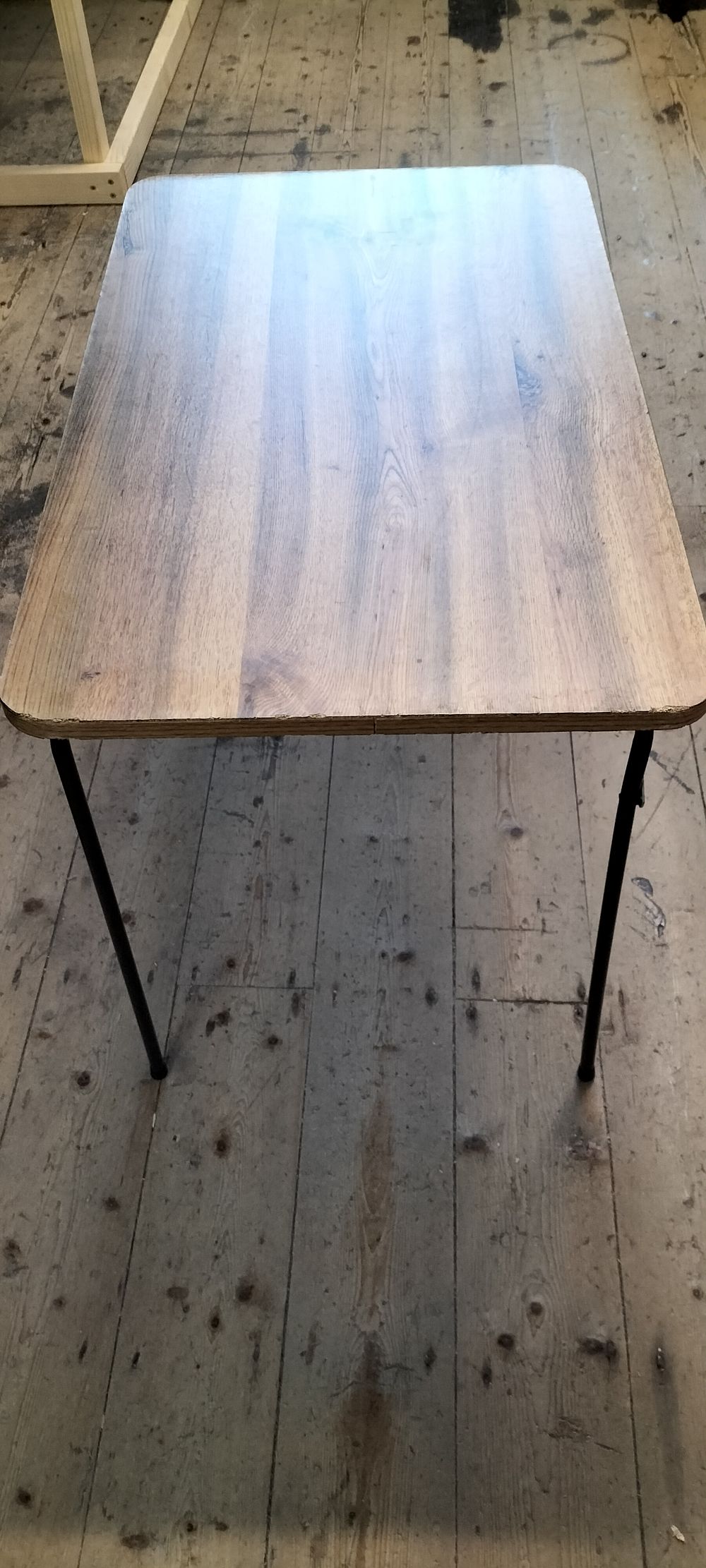 Lot 223: A Folding Tubular Metal and Wood Effect Laminate Trestle Table