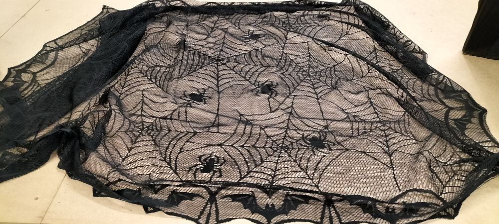 Lot 247: A Black Lace Spiderweb and Bat Pattern Table Cloth