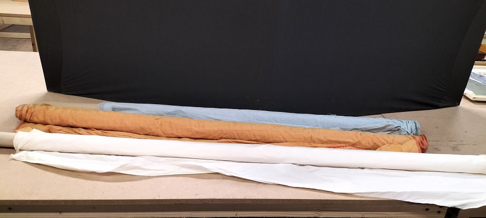 Lot 253: An Assortment of Three Rolls of Iridescent and Synthetic Fabric