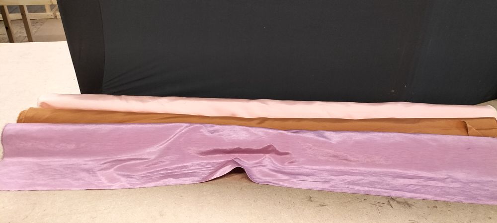 Lot 272: Three Partial Rolls of High Sheen Woven Fabric in Lilac Bronze and Pink