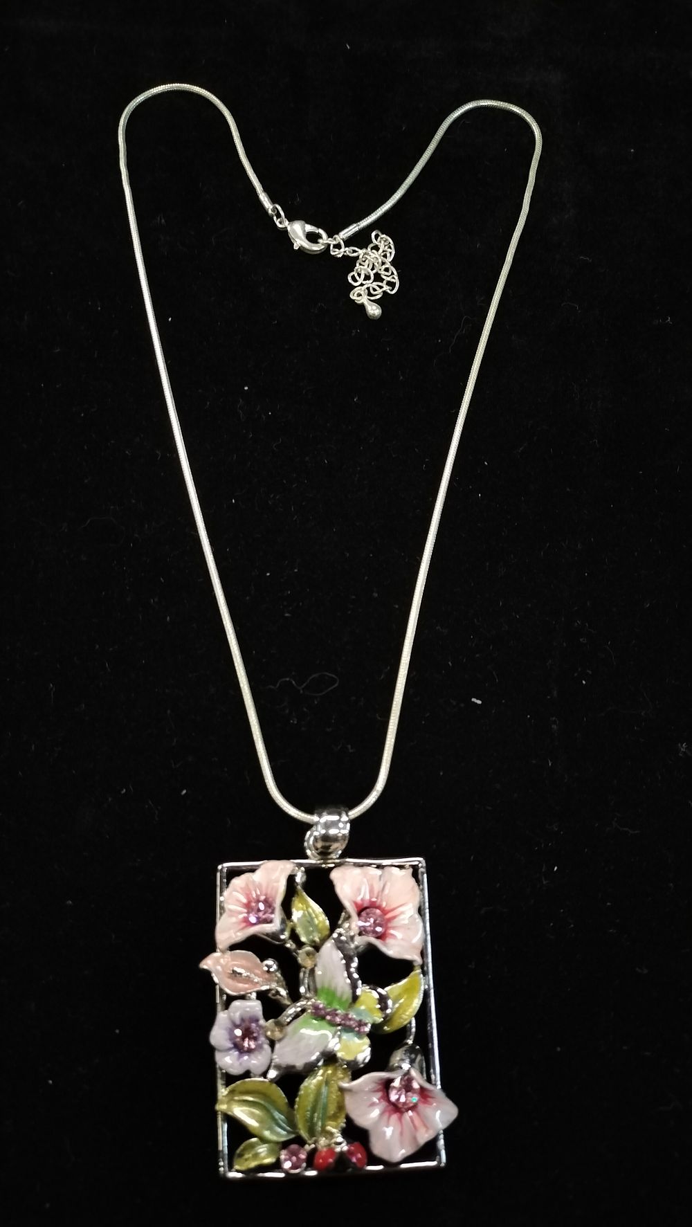 Lot 431: A Silver Toned Enamelled Floral and Butterfly Pendant Necklace