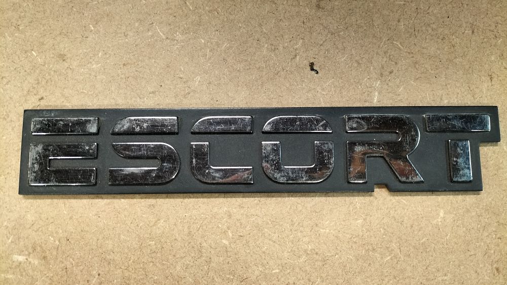 Lot 439: A Ford Escort Plastic Trunk Lid Emblem Badge