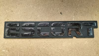 A Ford Escort Plastic Trunk Lid Emblem Badge