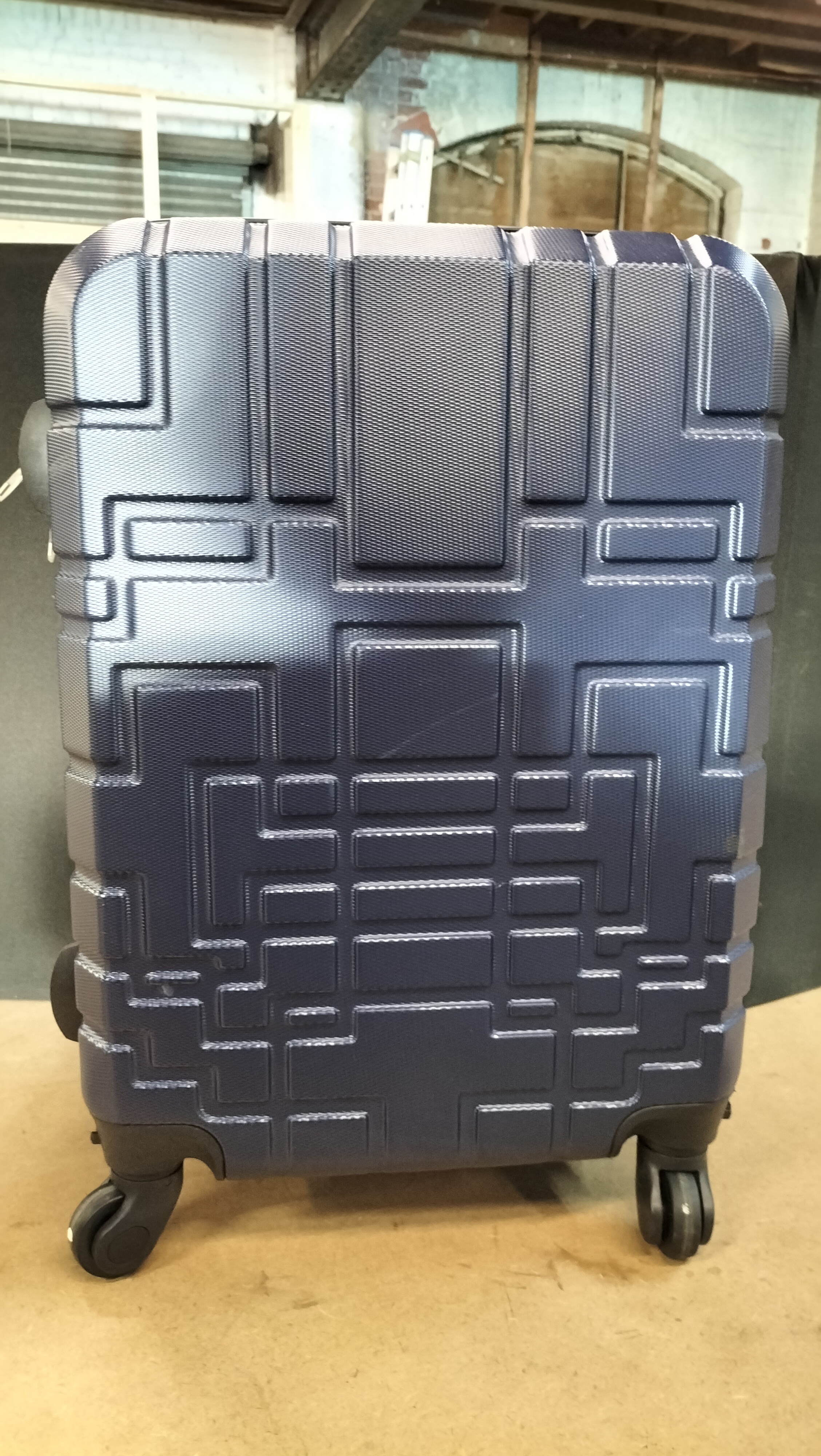 A Navy Blue Hard Shell ORLAGS Geometric Relief Four-Wheel Spinner Suitcase