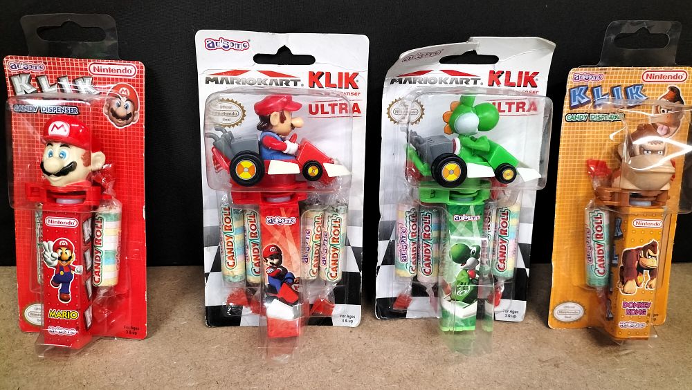 Lot 179: A Collection of 4 Factory Sealed Nintendo Au'some KLIK Candy Dispensers