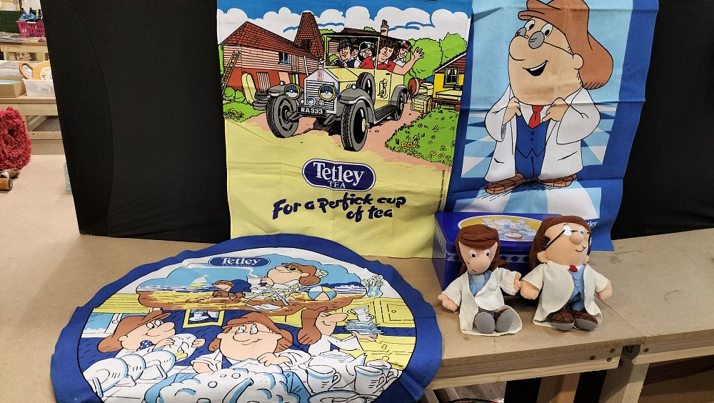 Lot 273: A Collection of Tetley Tea Folk Advertising Textiles, Plush Toys and Metal Tin