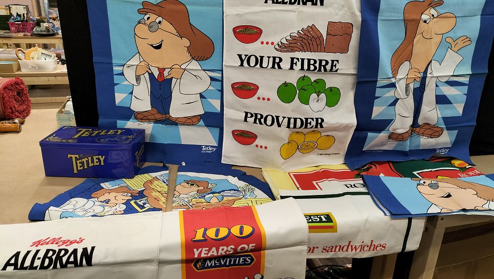 Lot 274: A Collection of Promotional Food and Drink Linens and a Tetley Tea Tin