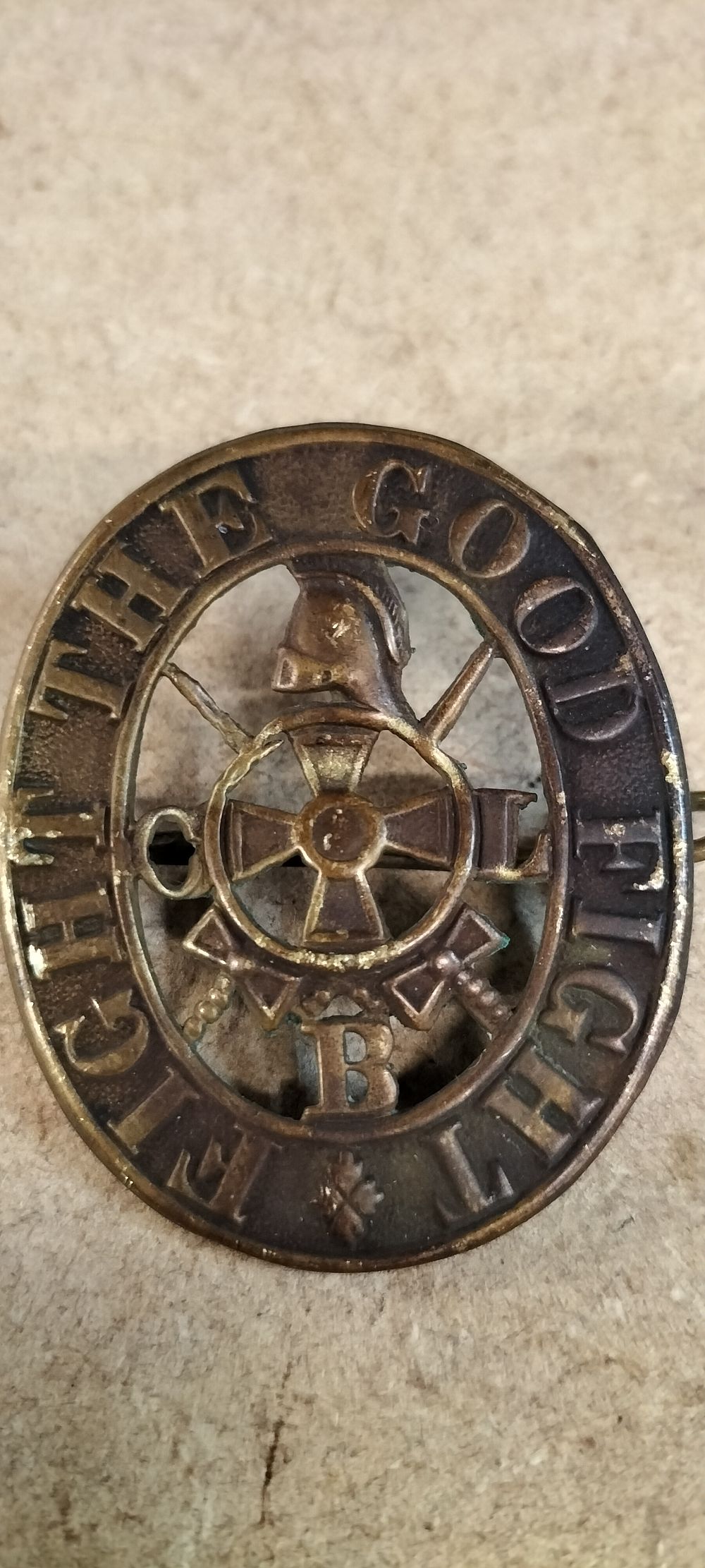 Lot 312: A Stamped Brass Oval Pin Back Badge Fight The Good Fight