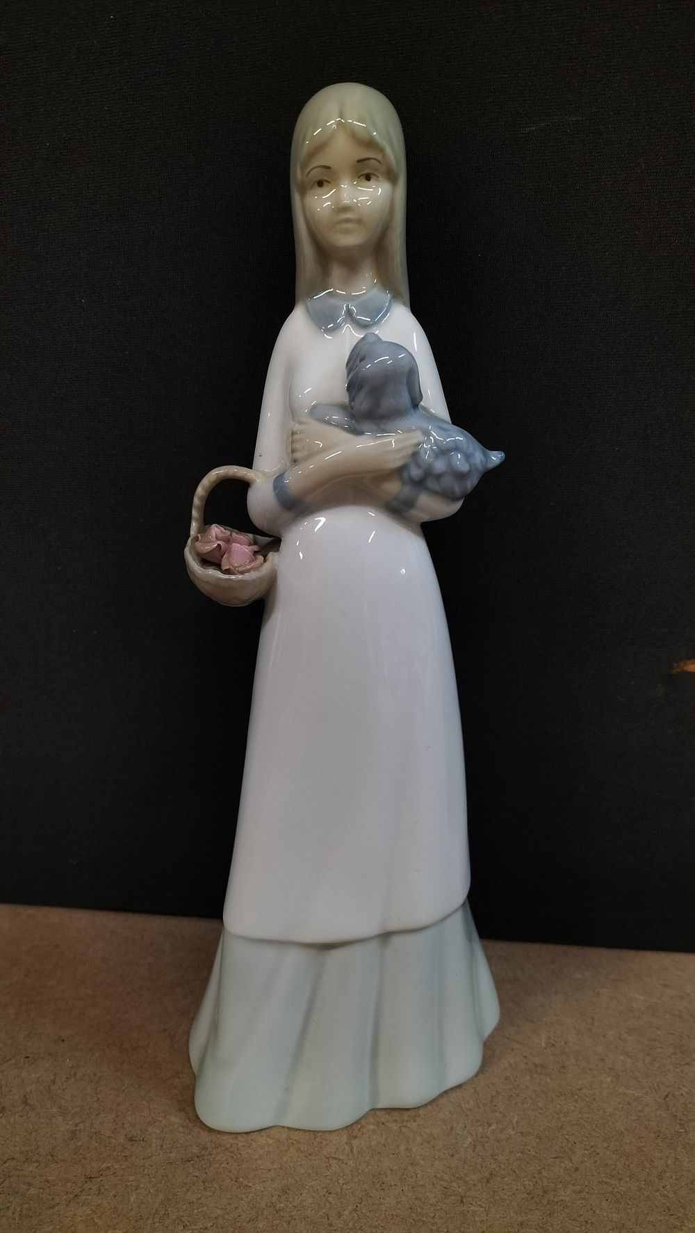 Lot 6: A Porcelanas Miquel Requena S.A. Glazed Porcelain Figurine of a Girl with Puppy
