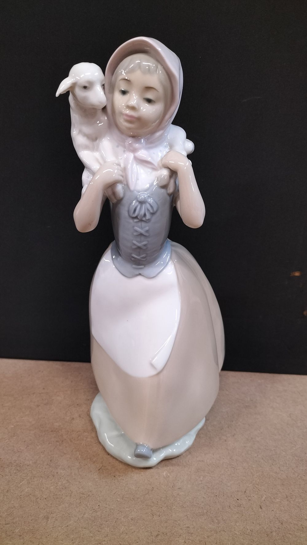 Lot 7: A NAO Glazed Porcelain Figurine of a Shepherdess with Lamb