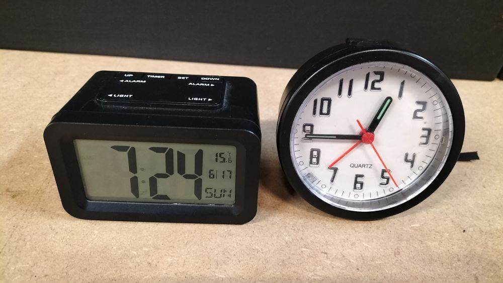 Lot 10: 2 Black Plastic cased Quartz Alarm Clocks including Sempre Model 91460