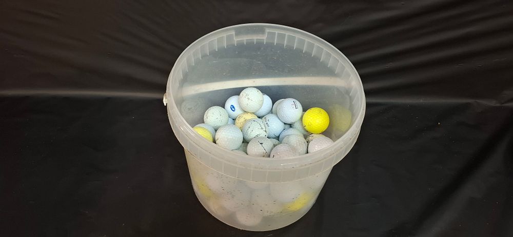 Lot 167: A Collection of Assorted Practice and Play Golf Balls in a Plastic Bucket