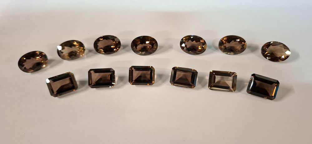 Lot 191: An Assortment of 13 Loose Chocolate and Smokey Topaz Gemstones