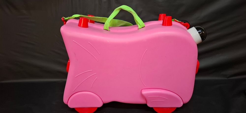 Lot 204: A Pink Moulded Plastic Ride-On Suitcase