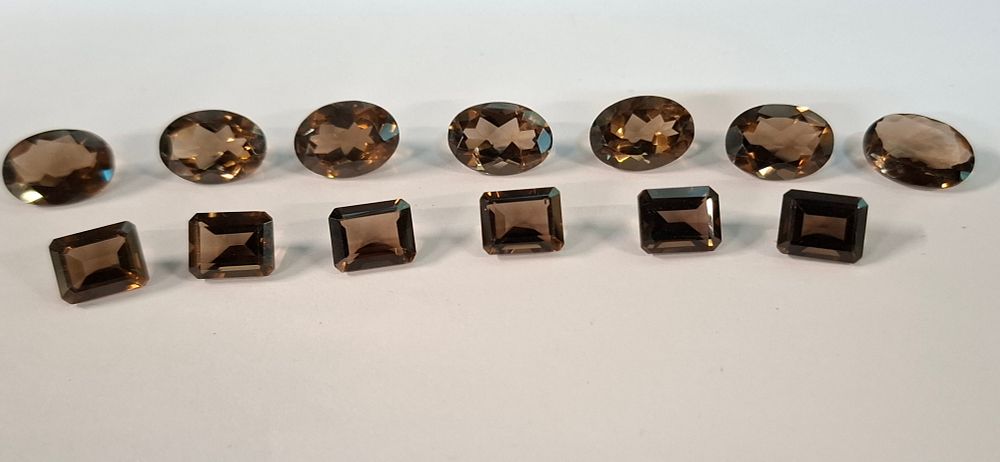 Lot 219: A Collection of 13 Faceted Chocolate and Smokey Topaz Loose Gemstones