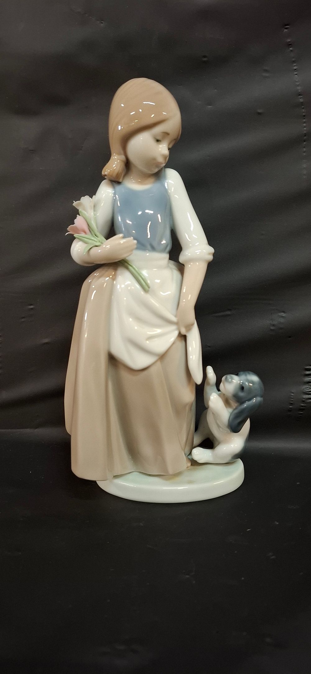 Lot 250: A NAO by Lladró Porcelain Girl with Puppy Figurine, 545