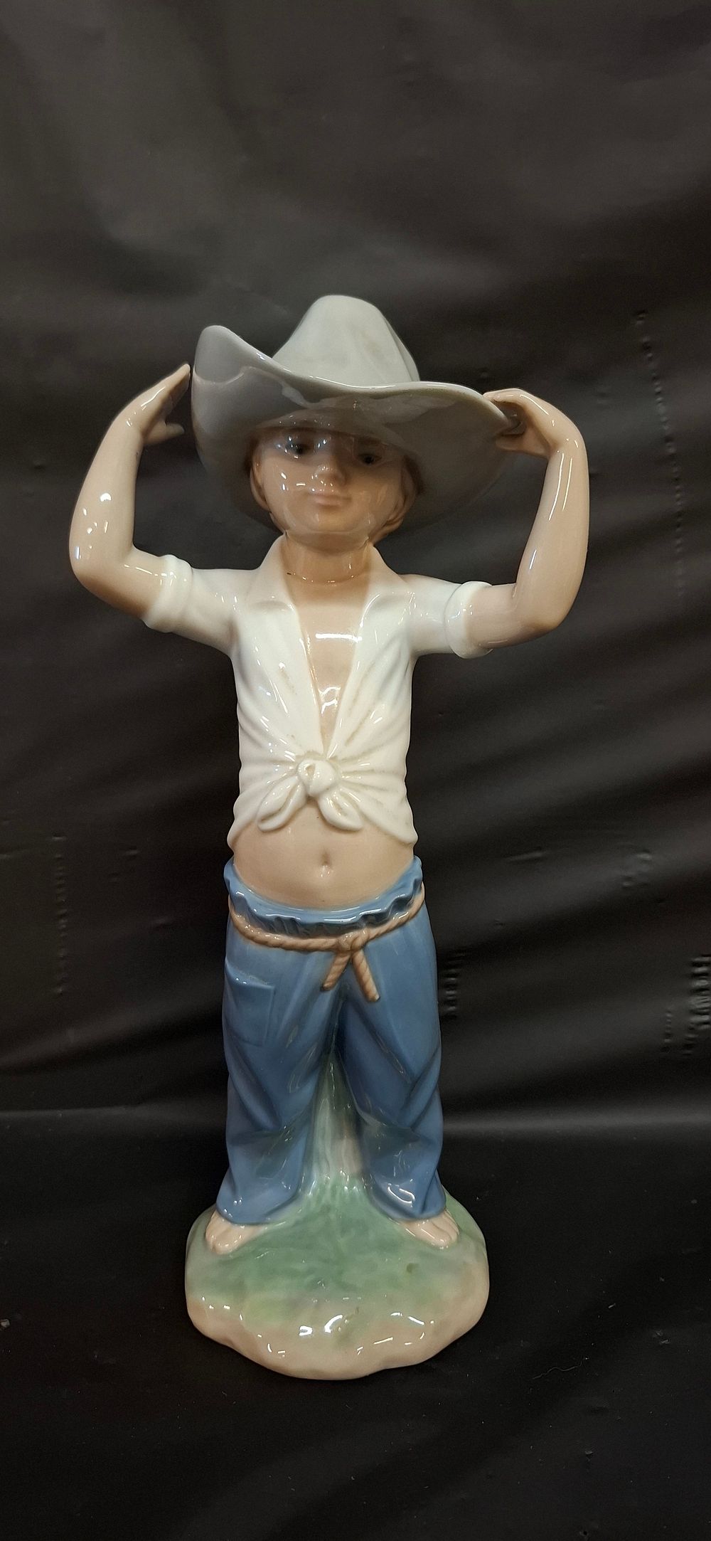 Lot 252: A NAO by LLADRÓ Porcelain Little Cowboy Boy Figurine, 182