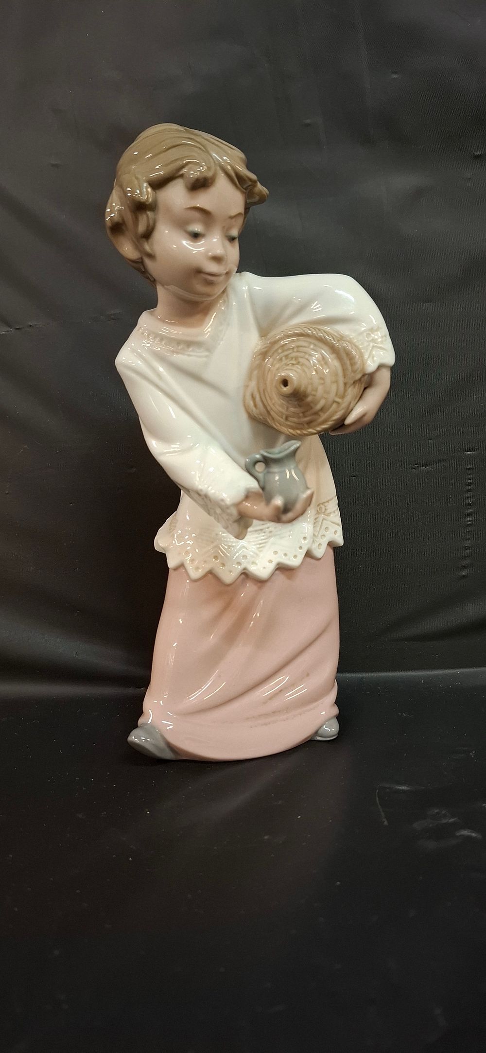 Lot 254: Nao by Lladro Glazed Porcelain Figurine of a Young Woman with Basket