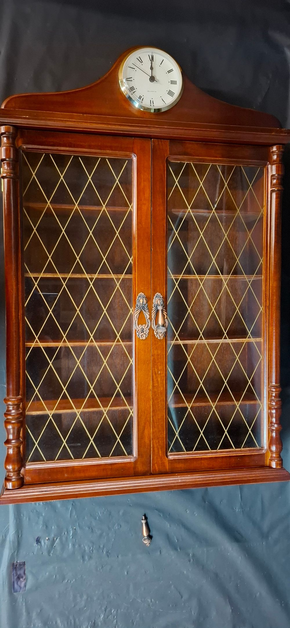 Lot 257: A Vintage Stained Hardwood Quartz Clock Display Cabinet