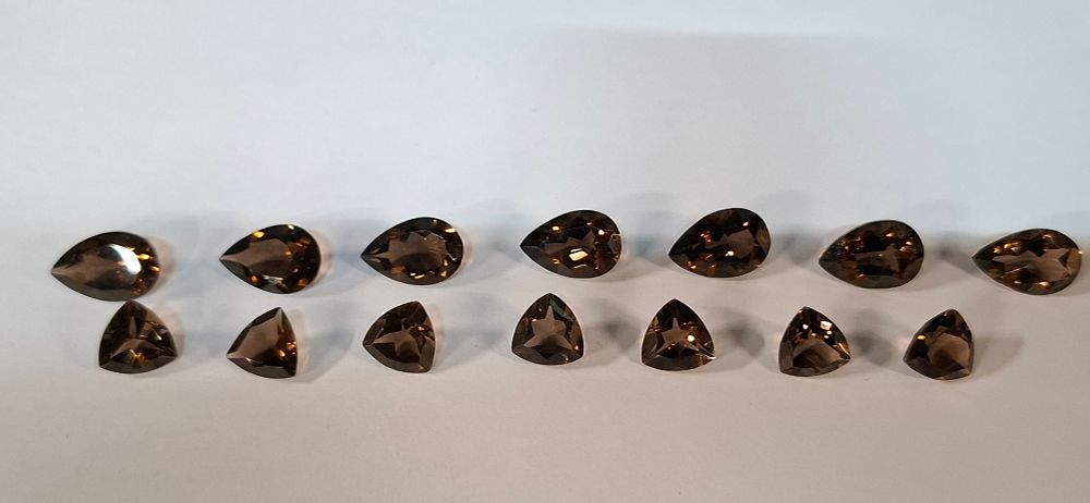 Lot 281: A Collection of 14 Faceted Smokey and Chocolate Topaz Loose Gemstones