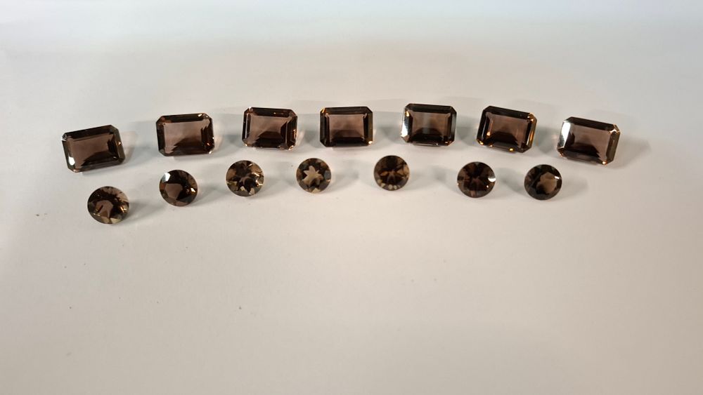 Lot 396: A Collection of 14 Faceted Smokey and Chocolate Topaz Loose Gemstones