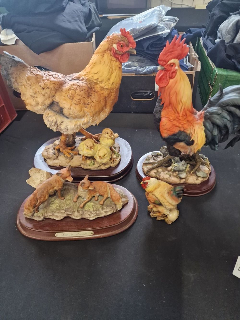 Lot 243: Four farm ornaments. One large rooster, large hen...