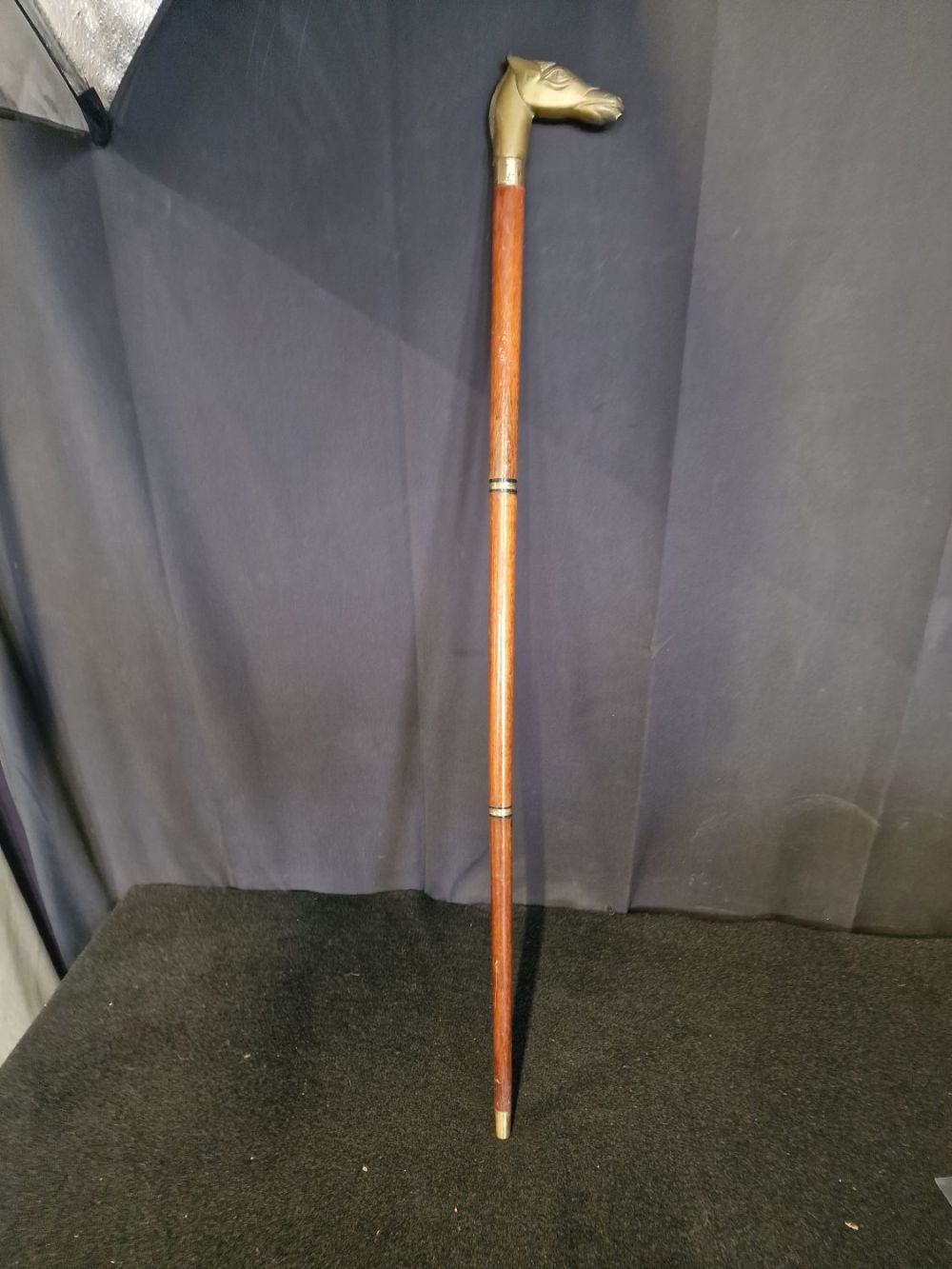 Lot 228: Vintage horse brass head walking stick. Comes inside...