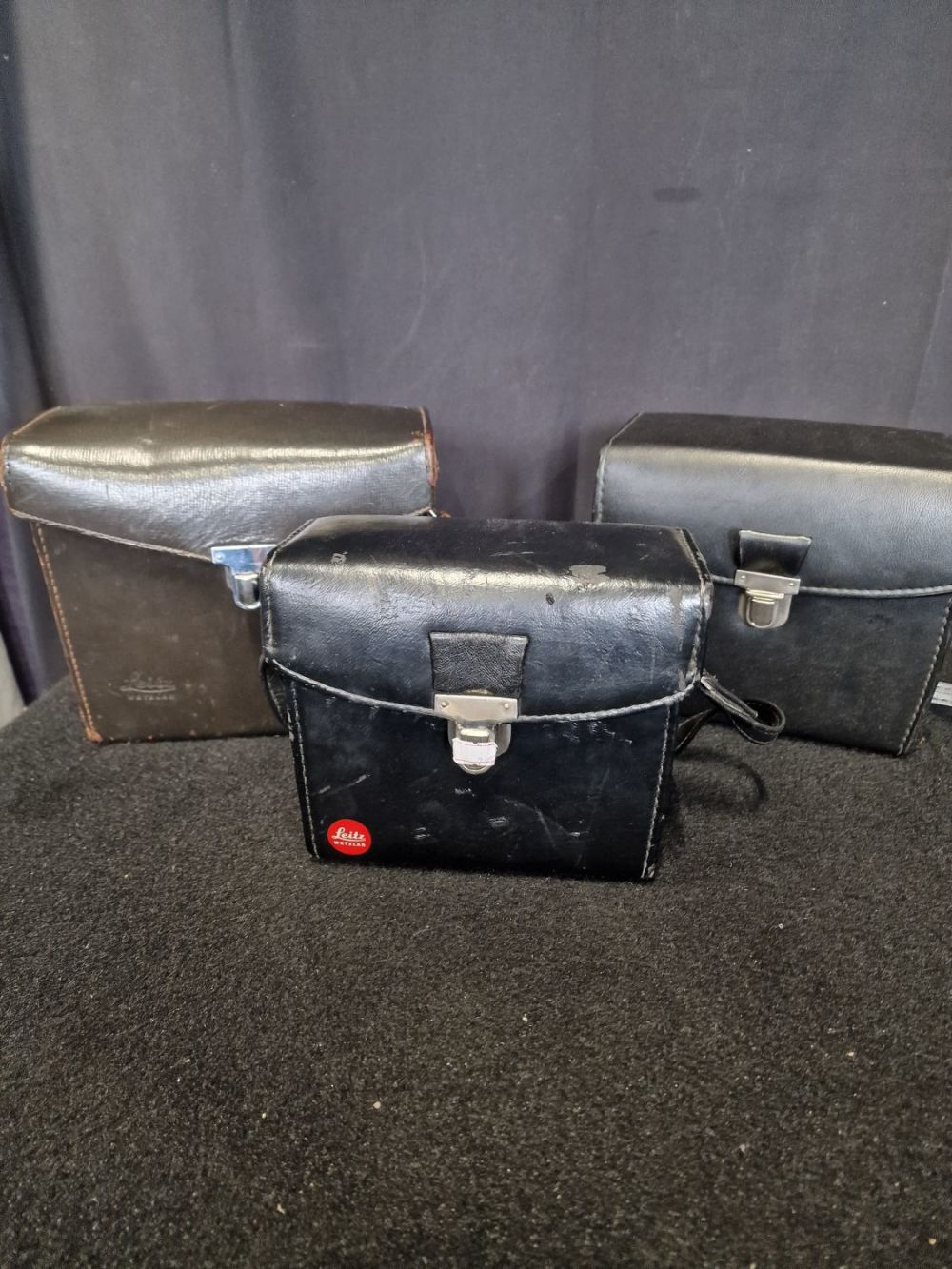 Lot 240: Three Leitz leather bound vintage camera cases with...