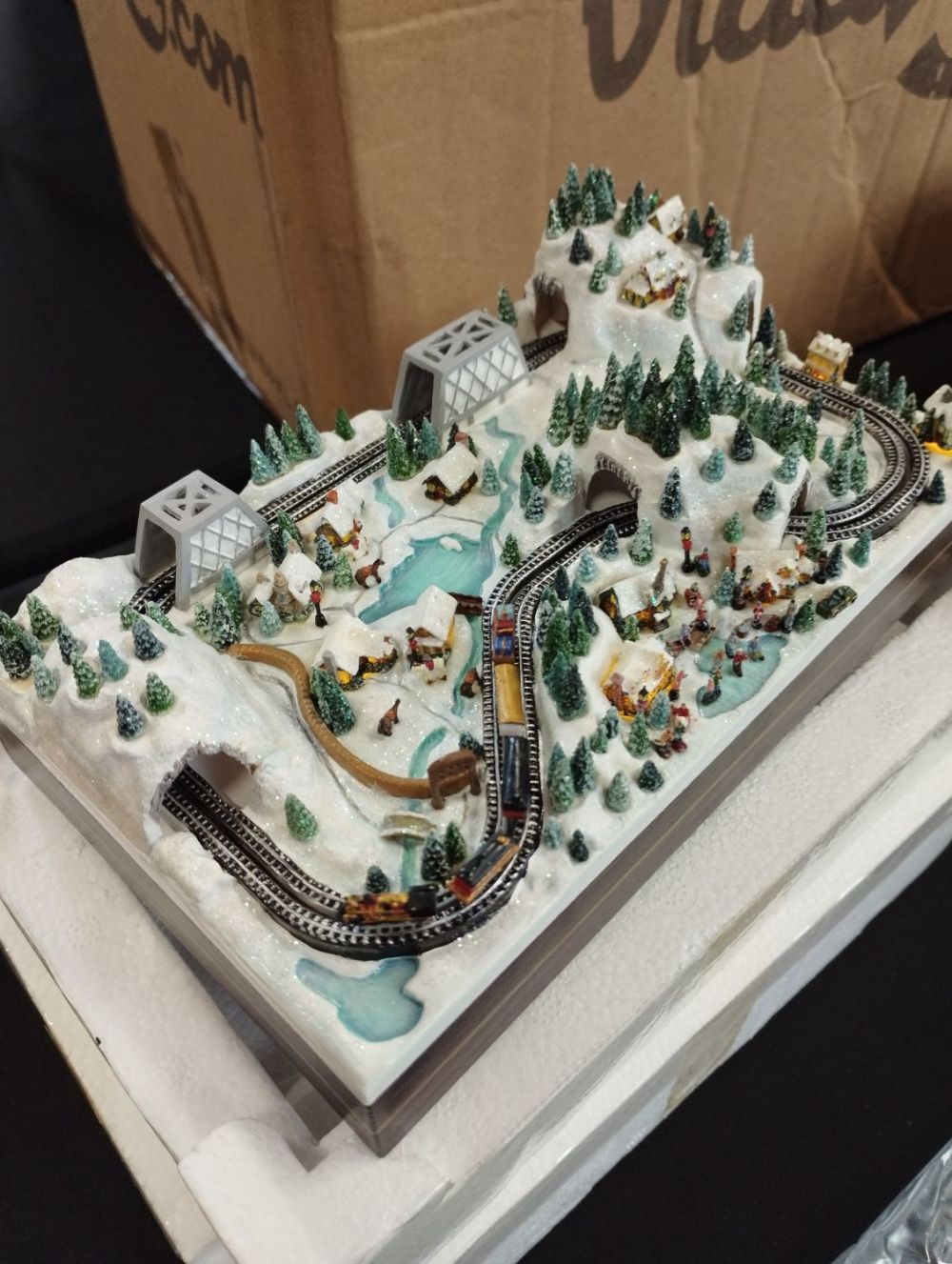 Lot 243: Thomas Kinkade Christmas Village Miniatures "Winding Through The...