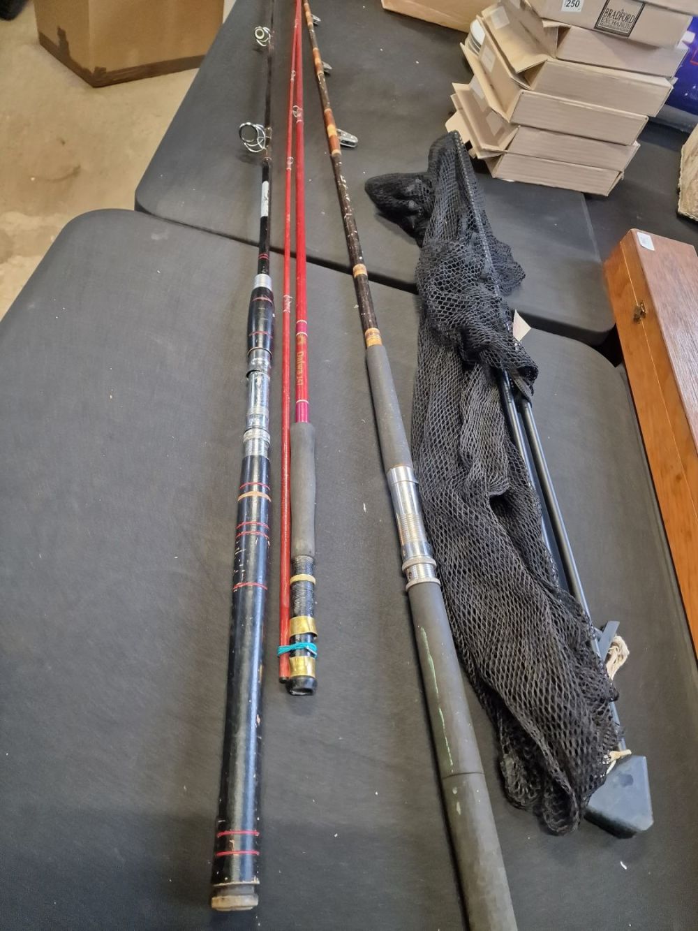 Lot 303: Three fishing rods and a Leeda landing net
