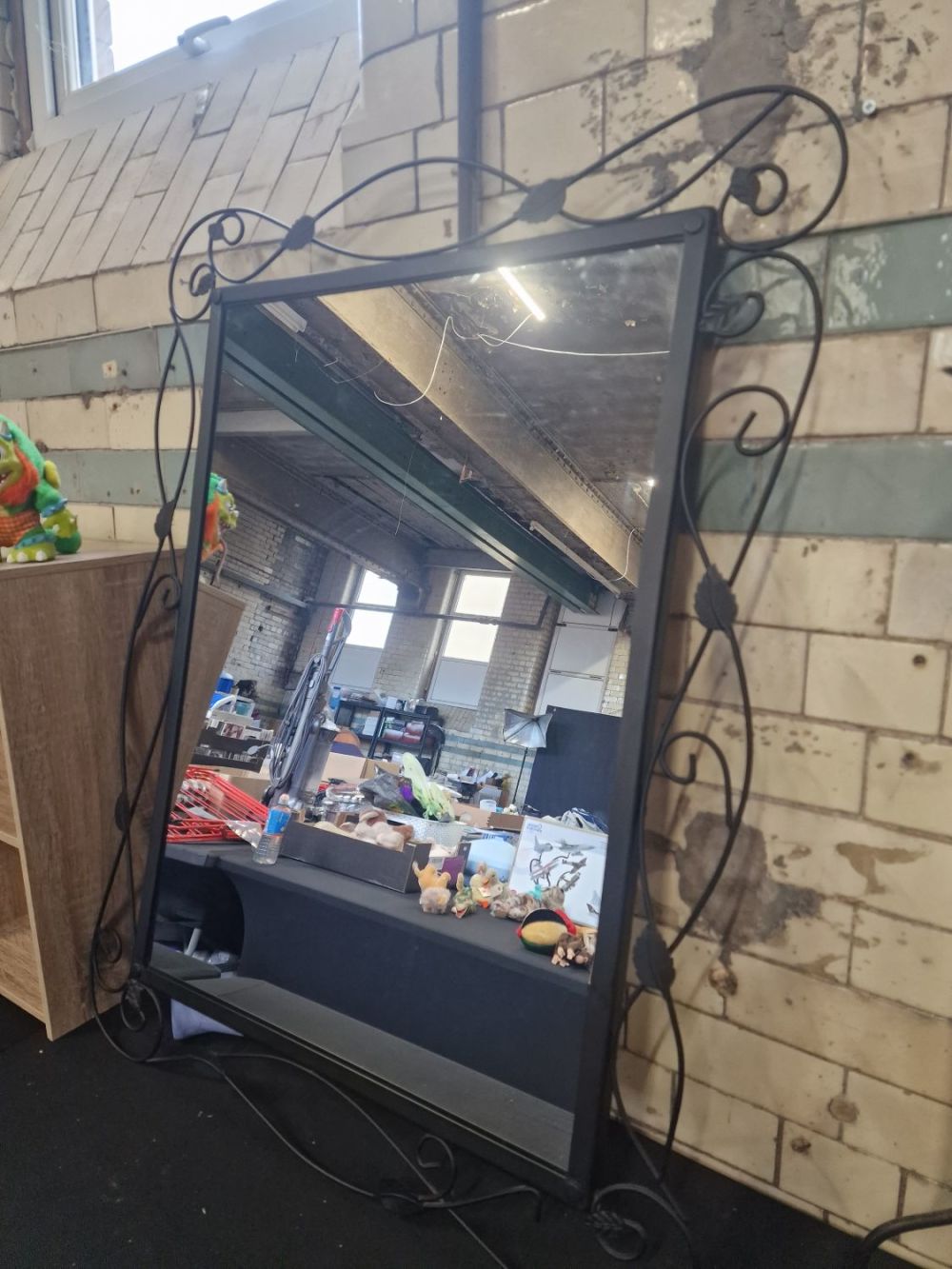 Lot 250: An wrought iron effect finish wall mirror dimensions...