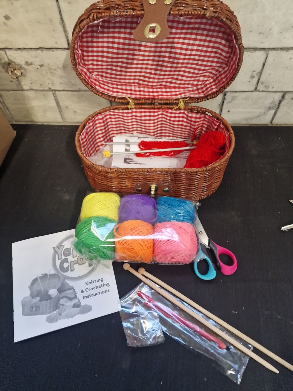 Lot 313: A wicker knitting box with wool, needles and...