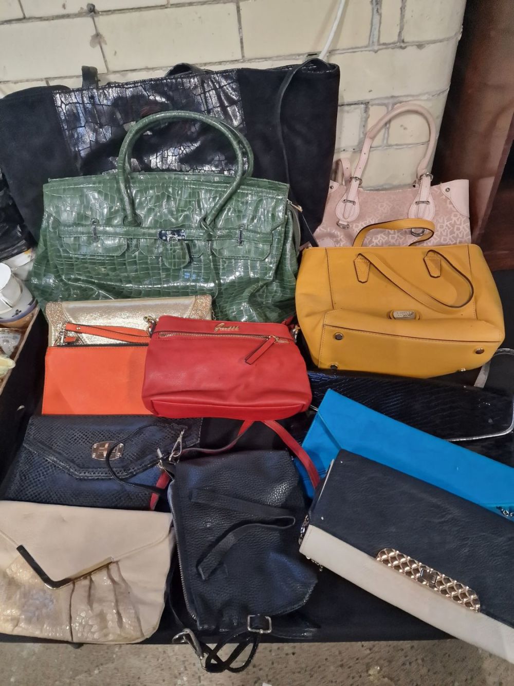Lot 343: A mixed.collection of hand bags, includes GUESS, warehouse...
