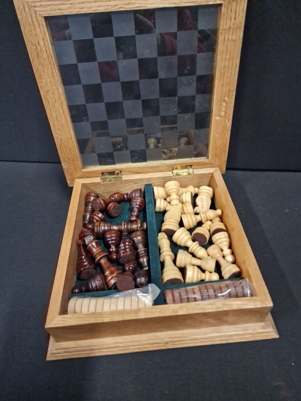 Lot 111: Mini chess and drafts board, complete with pieces