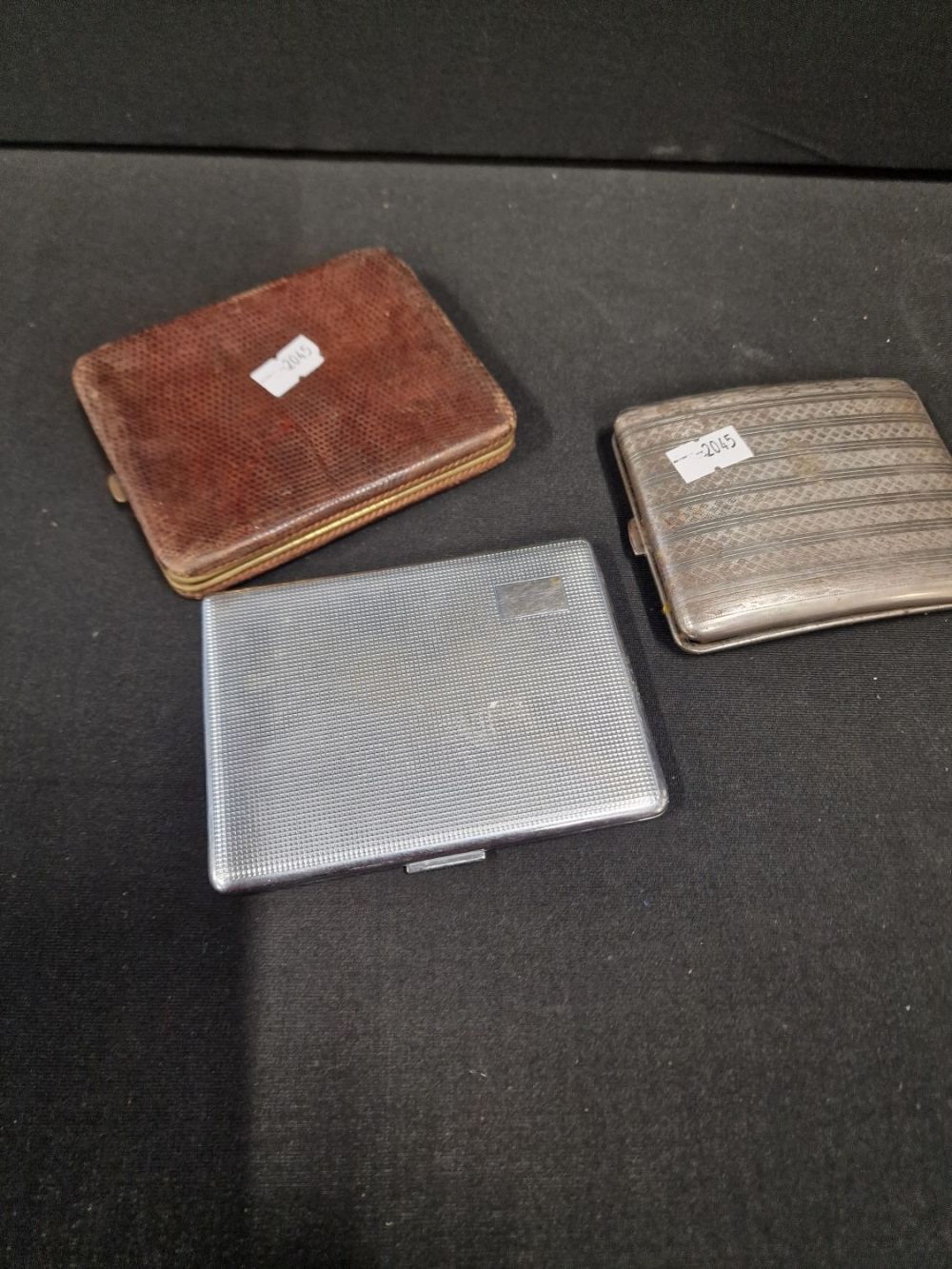 Lot 113: Three vintage metal and leather cigarette vaaes