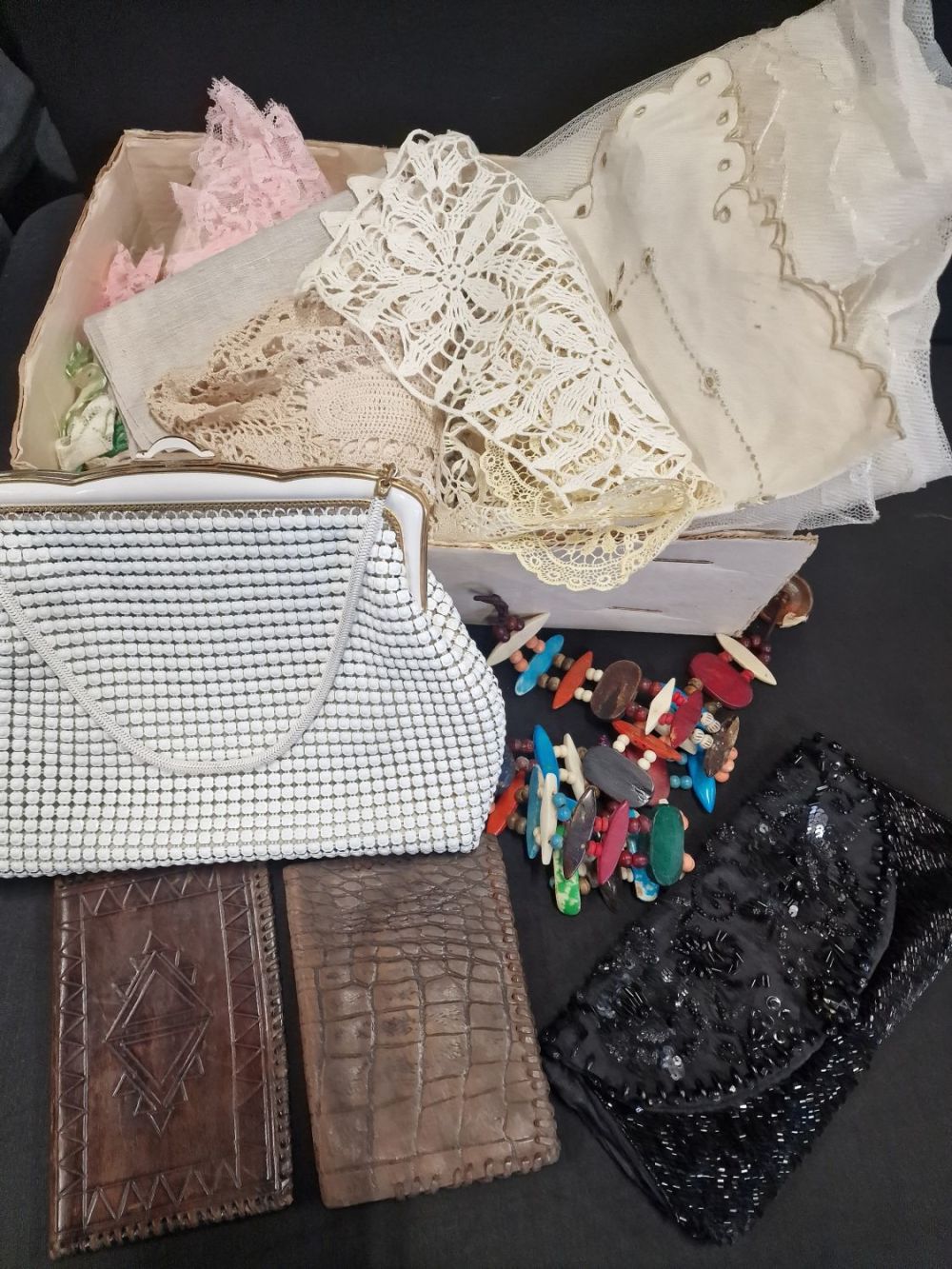 Lot 321: A collection of vintage, lace,.crochet,.hand bags and leather...