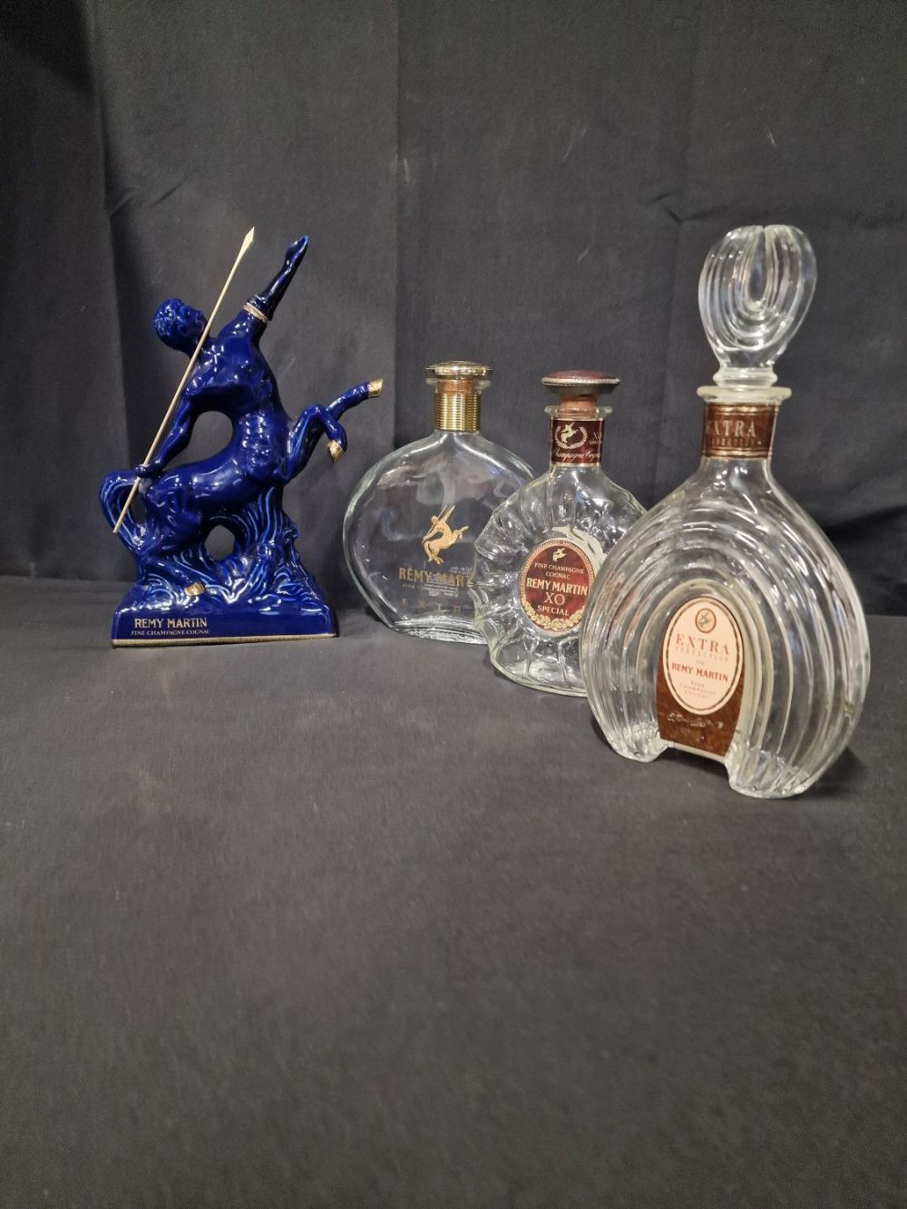 Lot 379: Four REMY MRTIN champagne Coganc bottles. Three clear...
