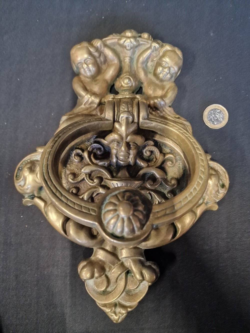 Lot 224: A large and heavy brass cherub door knocker