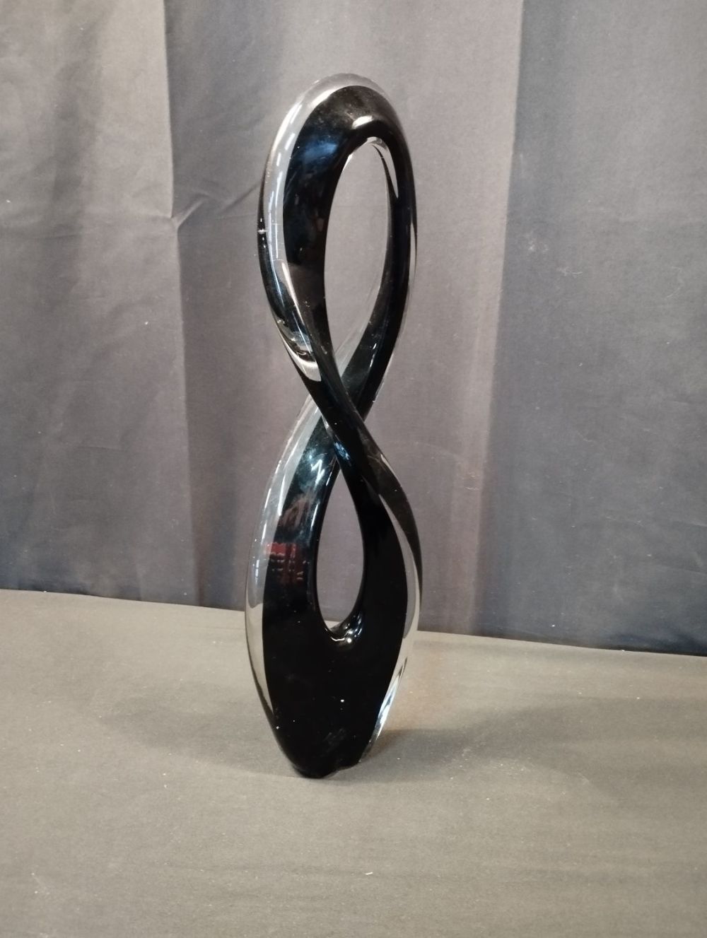 Lot 252: Black and Clear Glass Figure of Eight Sculpture....