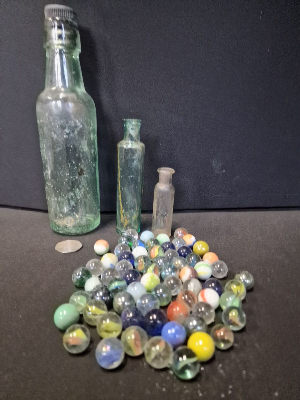 Lot 274: A collection of glass.vintage marbles and bottles