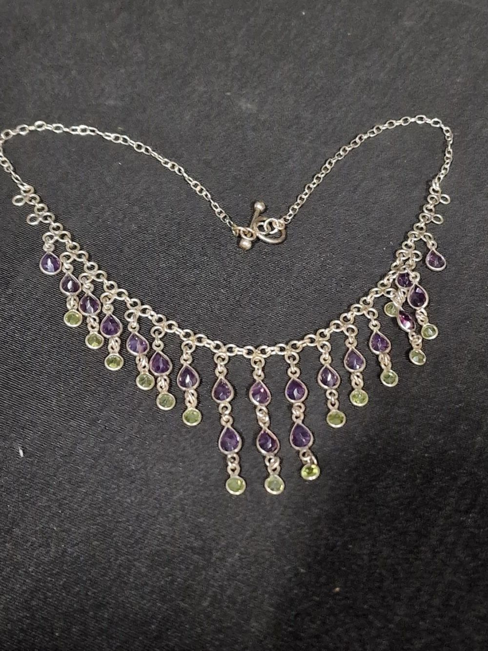 Lot 395: Sterling silver and amethyst droplet necklace.