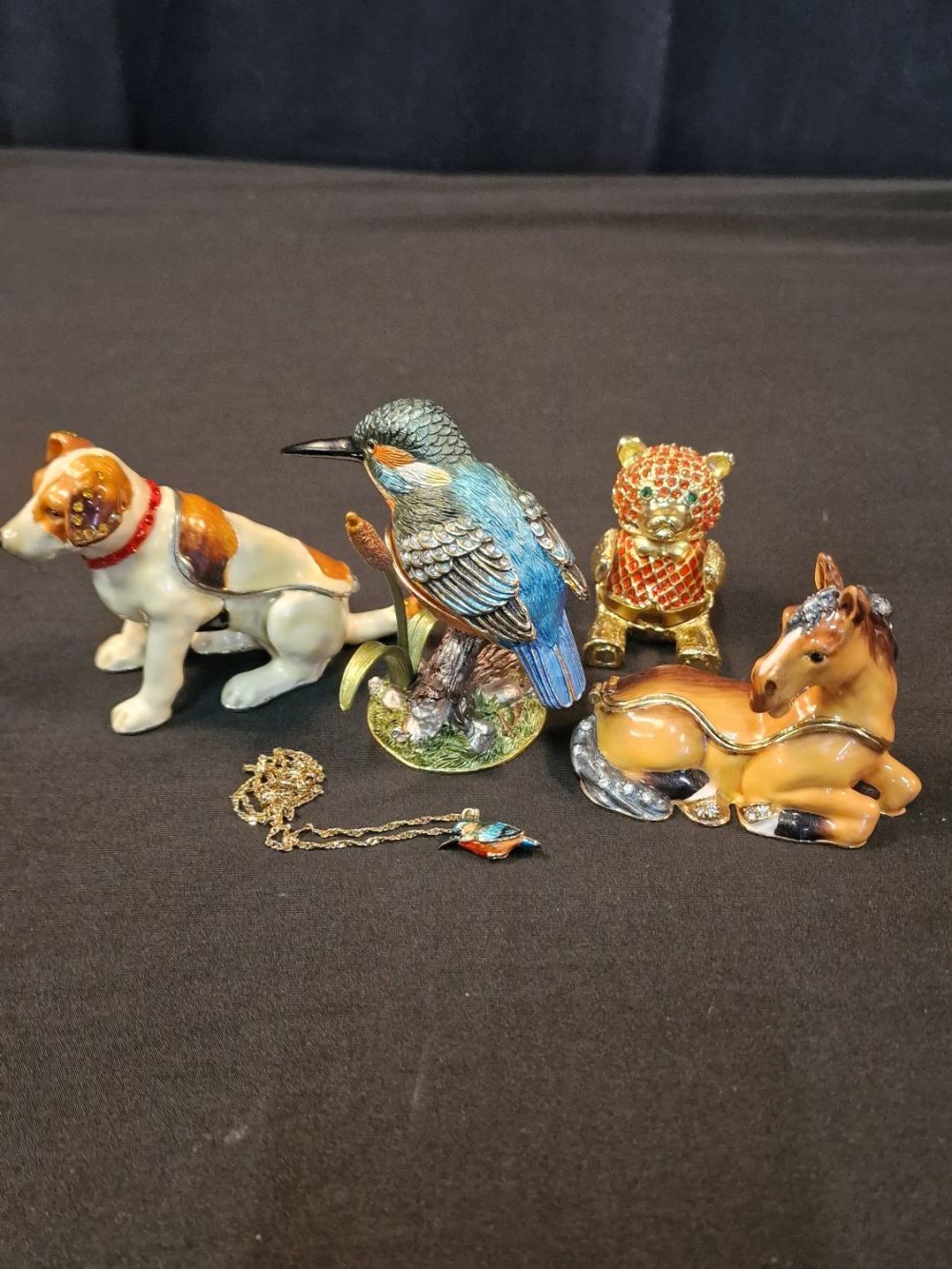 Lot 107: A collection of enamel and metal collectable trinket...