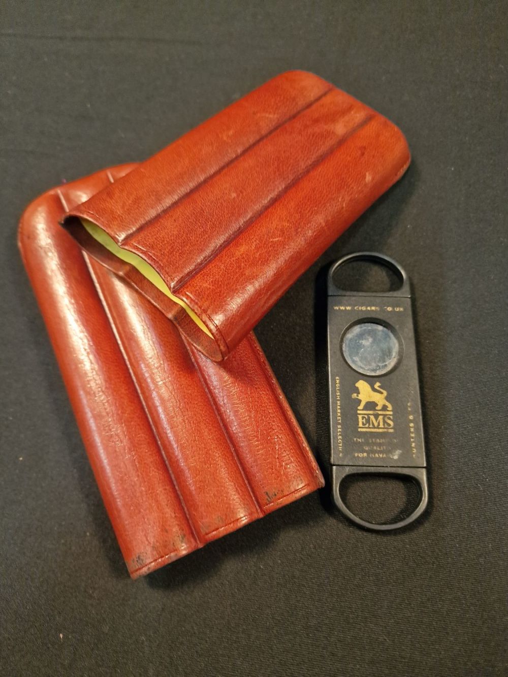 Lot 110: A genuine leather three slot cigar Wallet and...