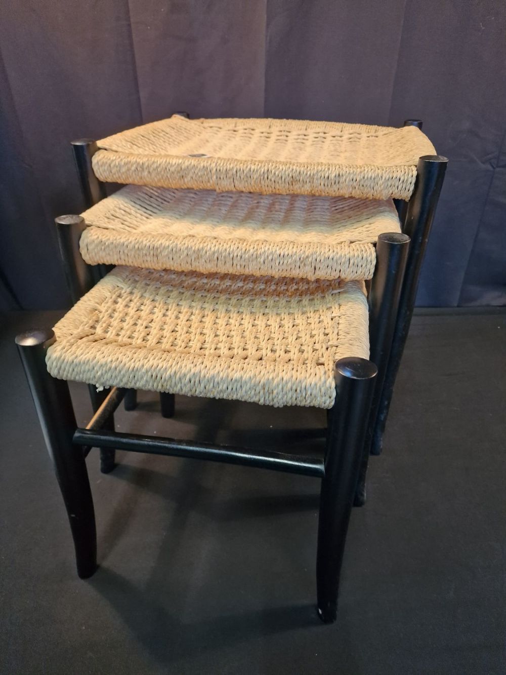 Lot 120: Mid-Century Ebonised & Woven Nesting Stools, 1950s, Set...