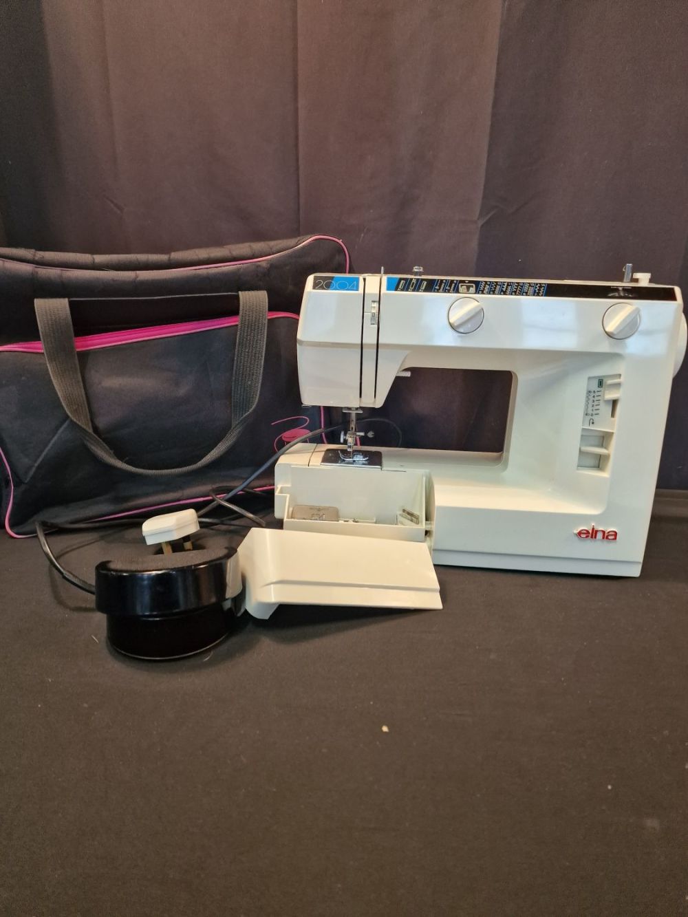 Lot 124: An EINA 2004 sewing machine. Complete with power...