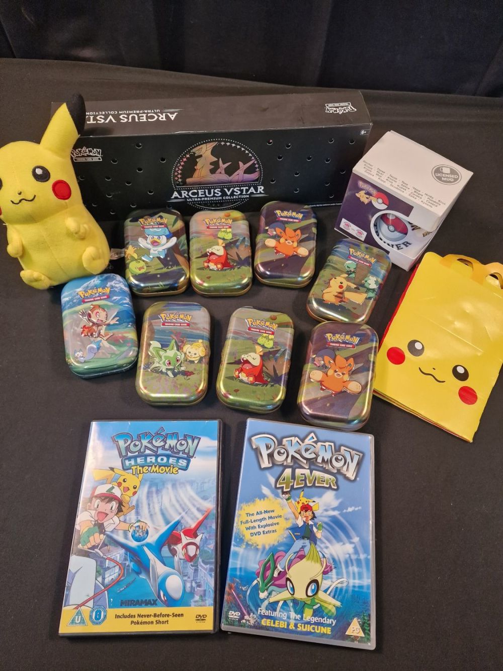 Lot 307: A collection of POKEMON includes 2 DVDS, 8...