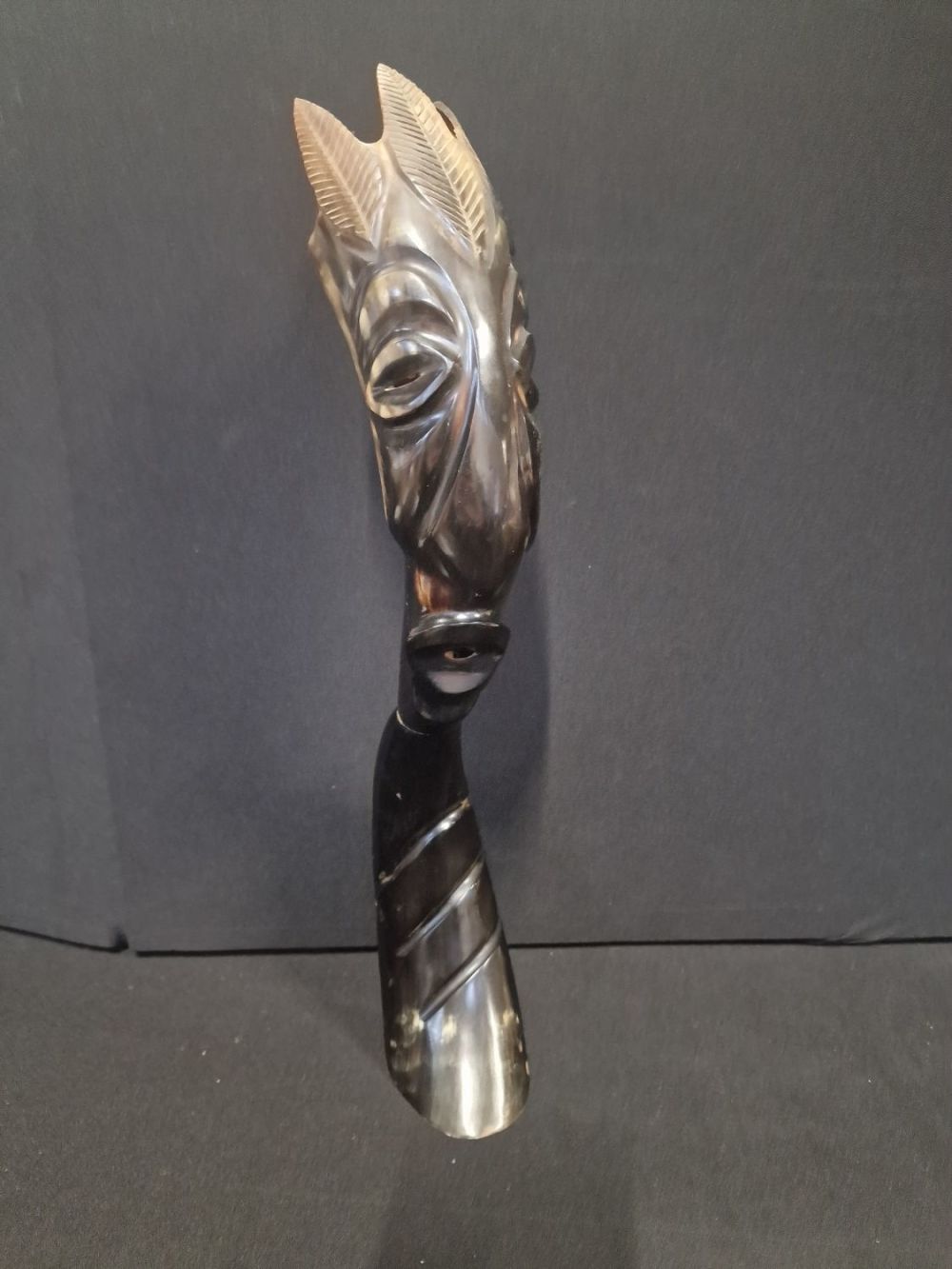 Lot 22: A vintage hand carved cattle horn African figure.